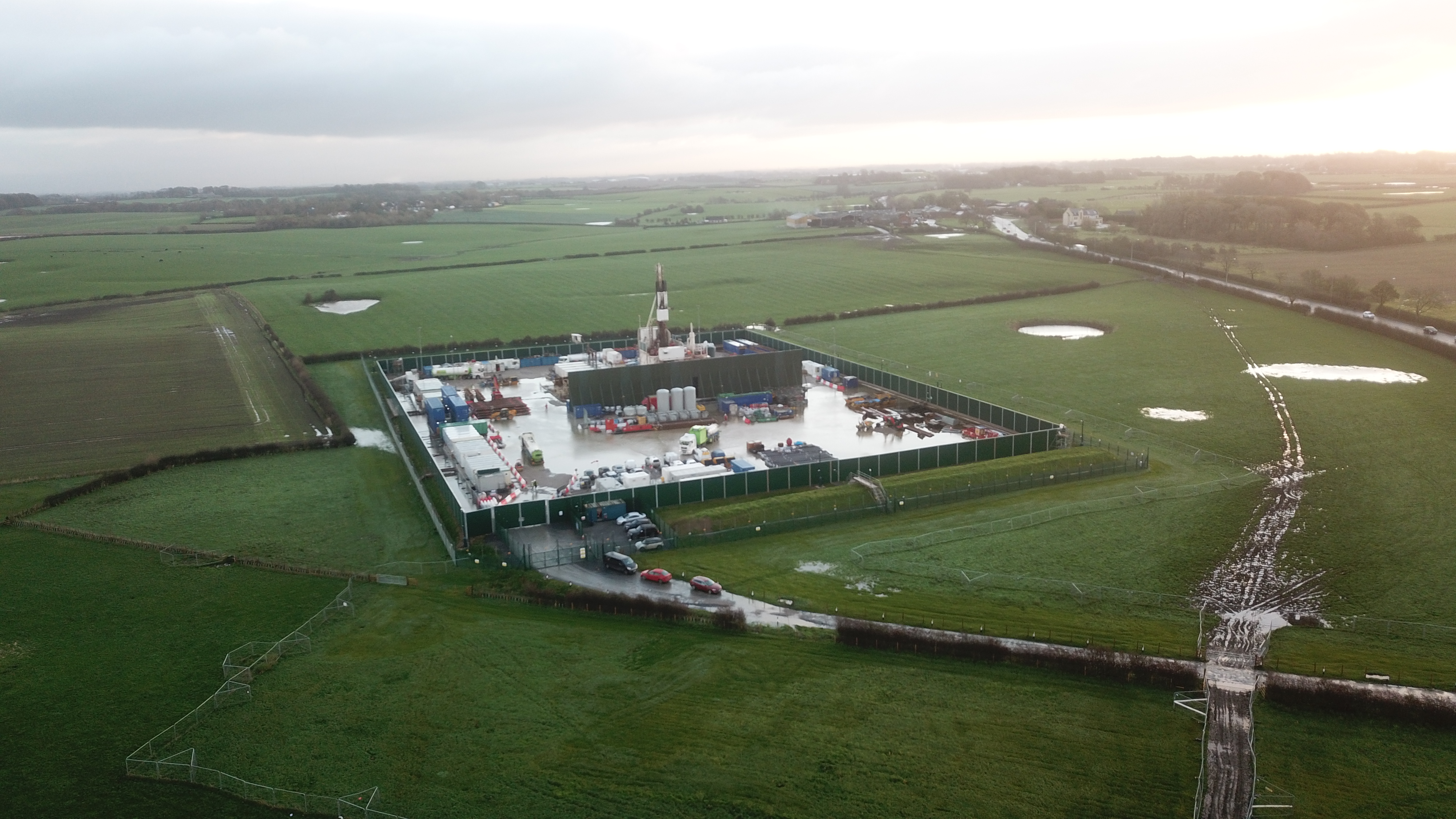 Aerial view of the Preston New Road well pad during operations, with extensive standing water and waterlogged tracks across the surrounding fields.